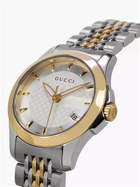 gold and silver gucci watch.